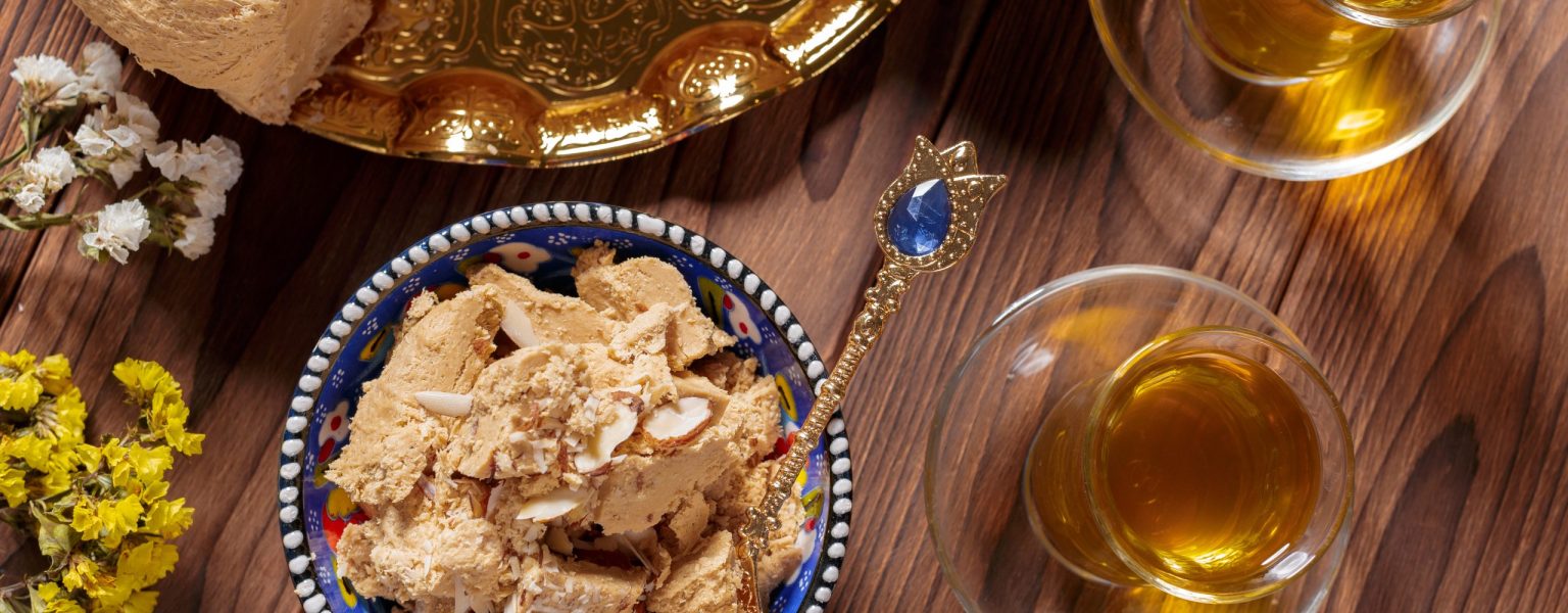 Tasty halva with tea on the table. Close up.